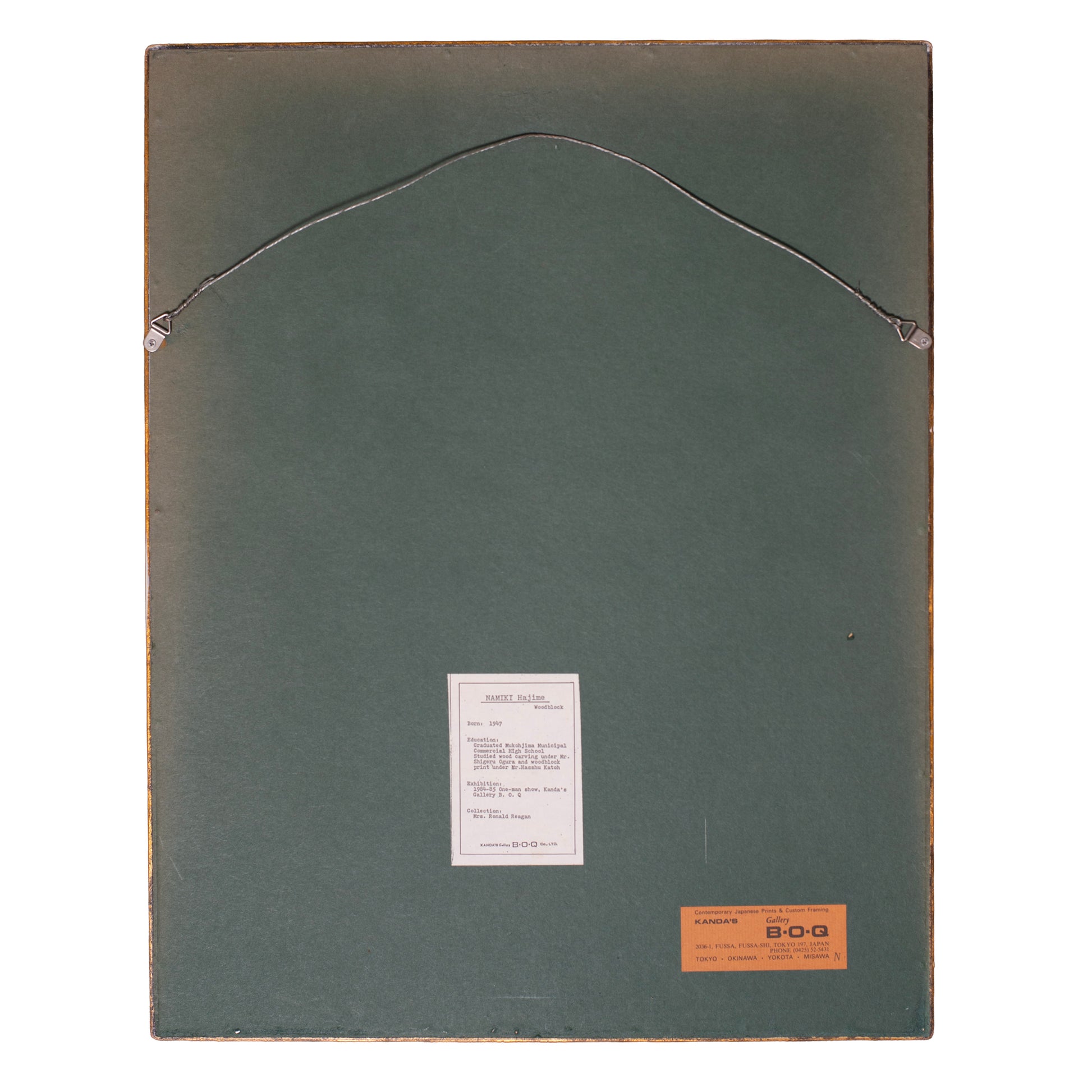 Back of a framed artwork with a label and brand name on a white background